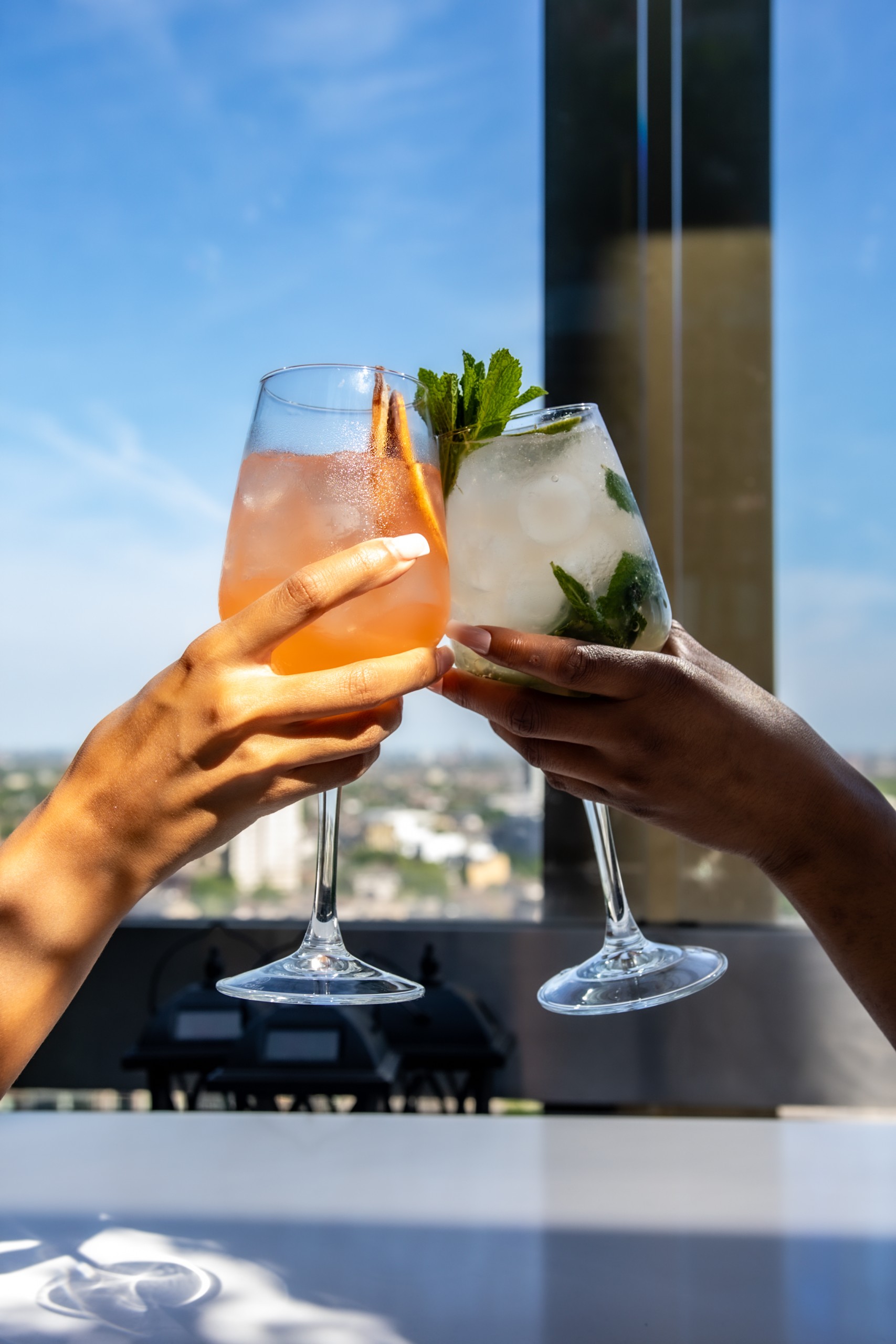 People celebrate by with cocktails on a terrace