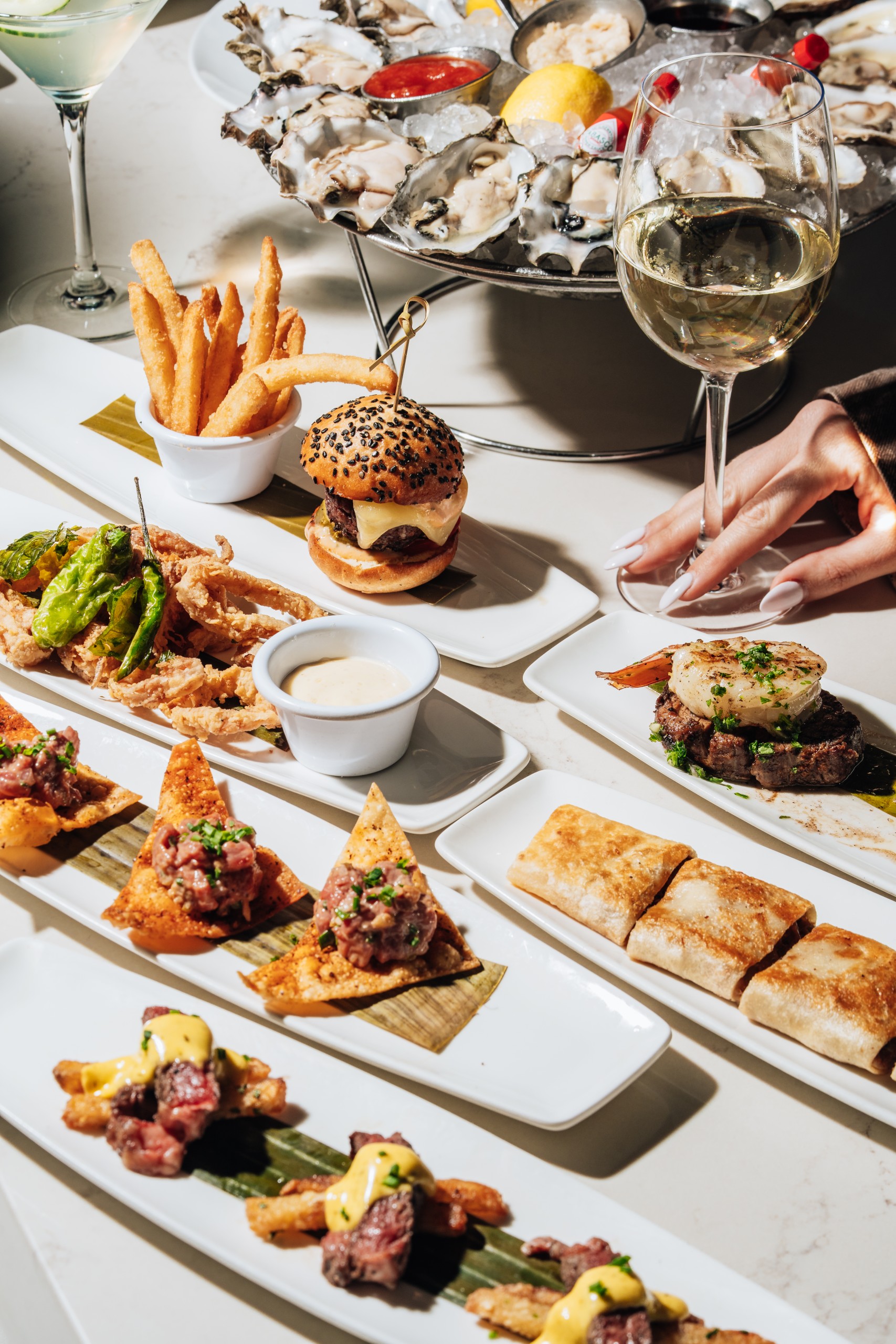 Spread of Happy Hour food - including: short rib quesadillas, & calamari