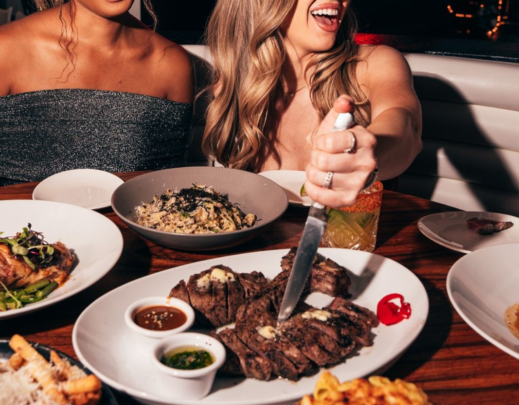 Girl stabbing steak with a knife